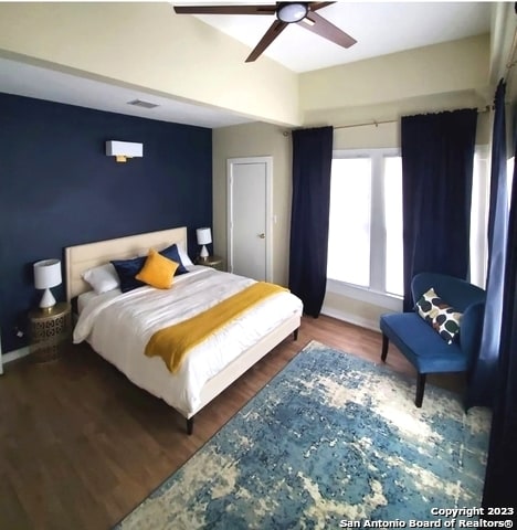 bedroom with ceiling fan and dark wood-type flooring