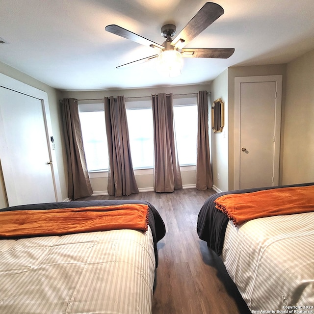 bedroom featuring ceiling fan and dark wood-type flooring