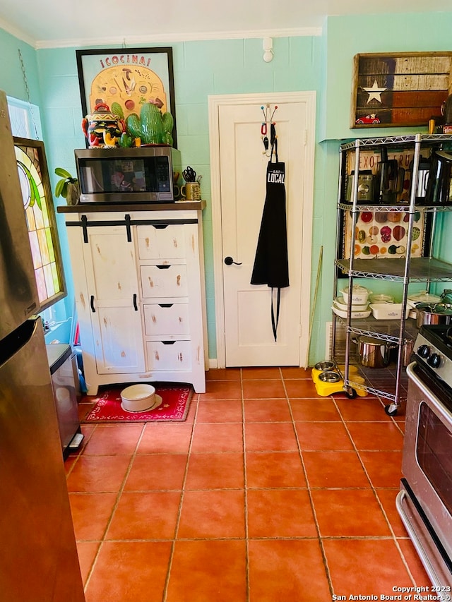 interior space with tile flooring, a wealth of natural light, and ornamental molding