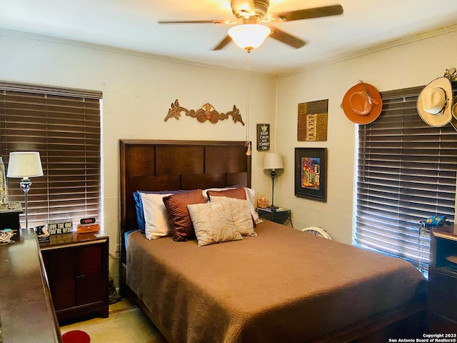 bedroom featuring ceiling fan and crown molding