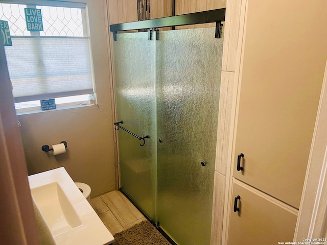 bathroom with tile flooring, toilet, and sink