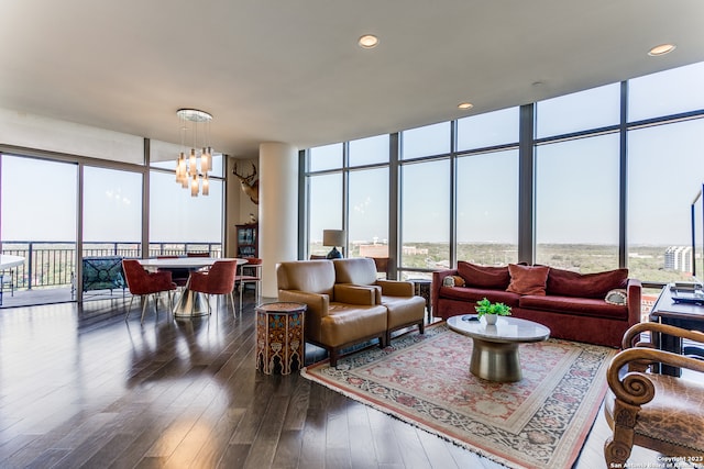 living room featuring expansive windows, a notable chandelier, and dark hardwood / wood-style floors