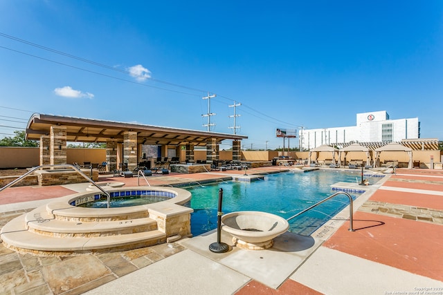 view of swimming pool with a community hot tub and a patio area