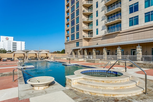 view of pool featuring a hot tub