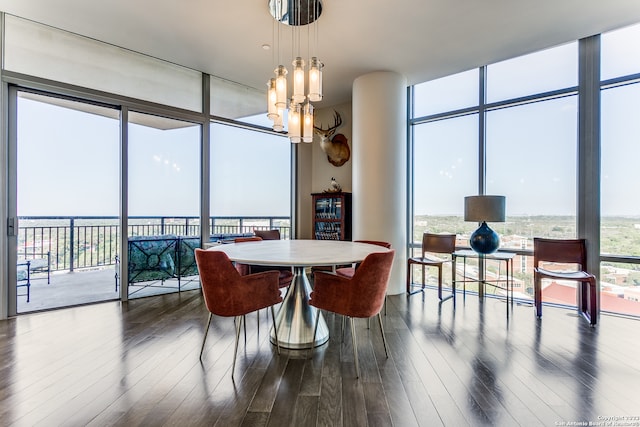 dining area featuring floor to ceiling windows, hardwood / wood-style floors, and a notable chandelier