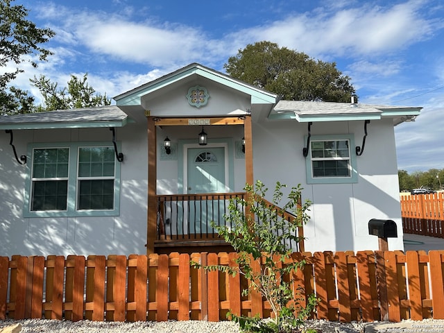 view of front of home featuring a fenced front yard and stucco siding