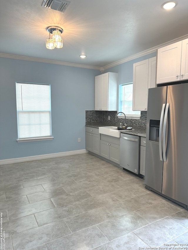 kitchen featuring appliances with stainless steel finishes, tasteful backsplash, sink, and light tile floors