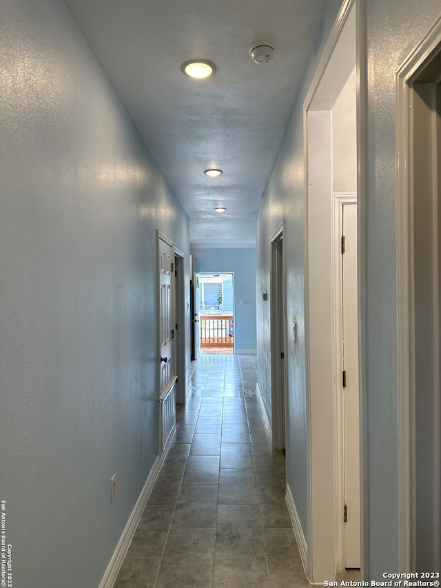 hall with dark tile floors