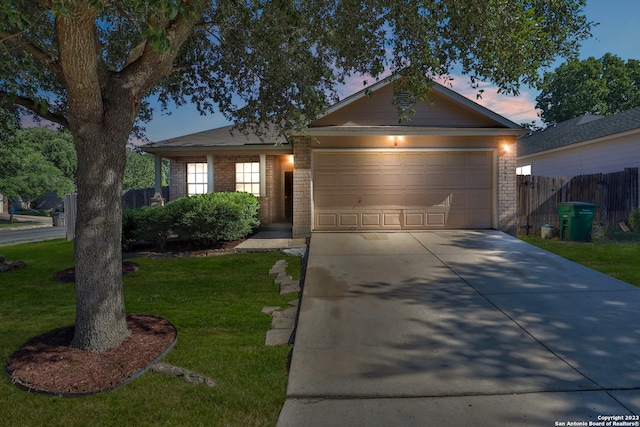 ranch-style house with a lawn and a garage