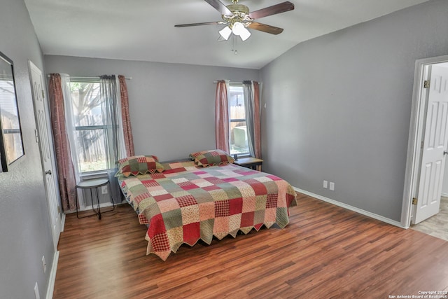 bedroom featuring ceiling fan, wood-type flooring, and lofted ceiling