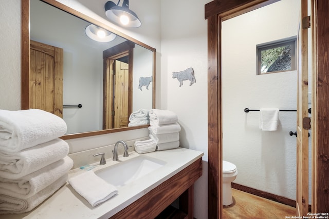 bathroom featuring oversized vanity and toilet