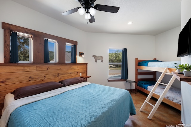 bedroom with dark colored carpet and ceiling fan