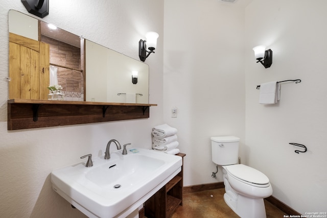 bathroom featuring toilet, tile floors, and sink