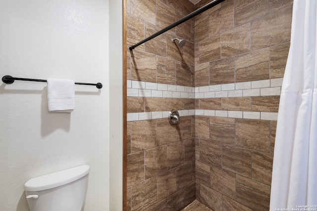 bathroom with a shower with curtain and toilet