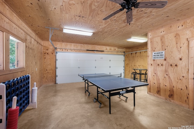 game room featuring wooden walls and ceiling fan