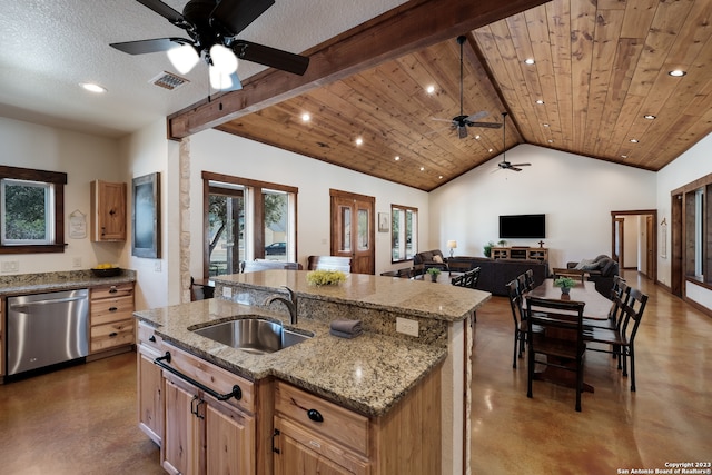 kitchen with a kitchen island with sink, sink, dishwasher, lofted ceiling with beams, and plenty of natural light