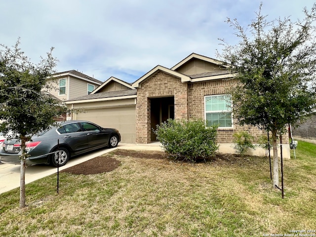 view of front facade with a front yard and a garage