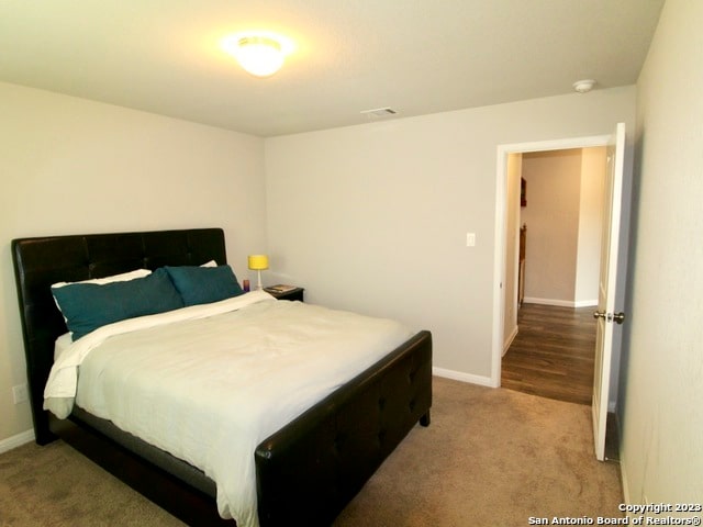 bedroom with light colored carpet