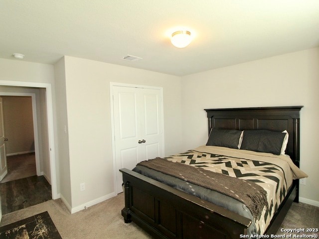 carpeted bedroom featuring a closet