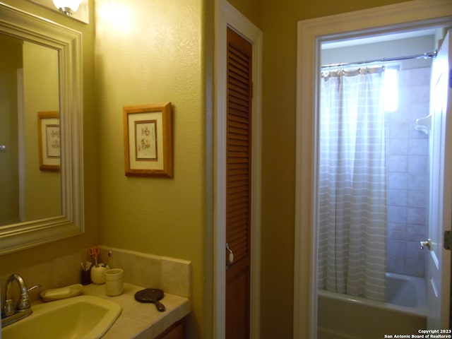 bathroom featuring vanity and shower / bath combo with shower curtain