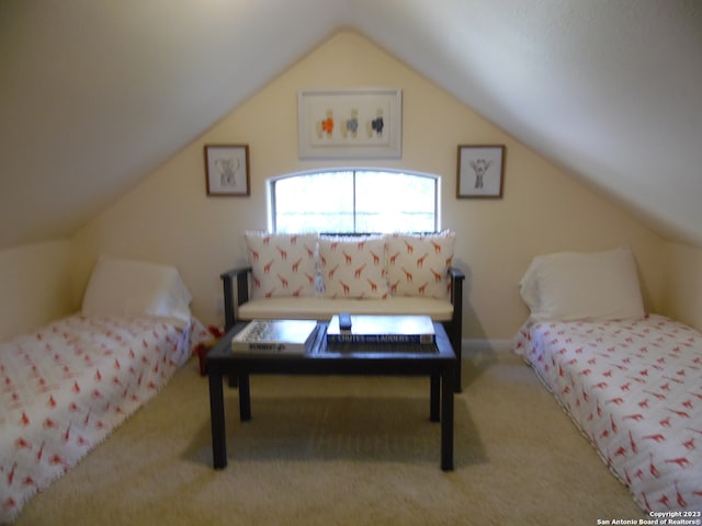 bedroom with light colored carpet and vaulted ceiling