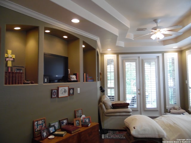 bedroom with a raised ceiling, access to outside, multiple windows, and ceiling fan