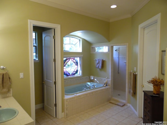 bathroom featuring shower with separate bathtub, ornamental molding, tile floors, and vanity