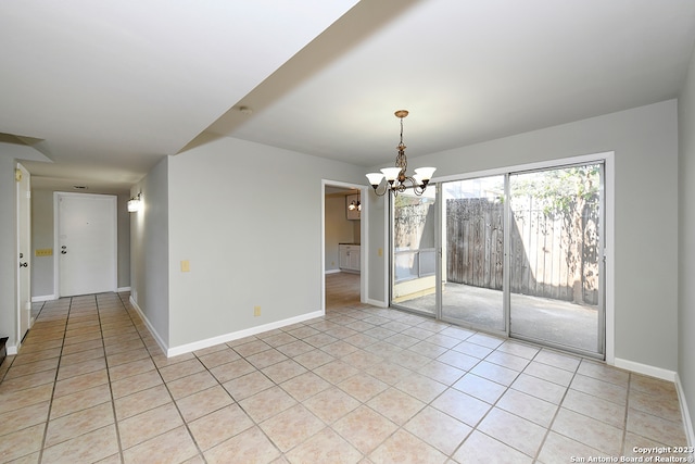 tiled empty room with a notable chandelier