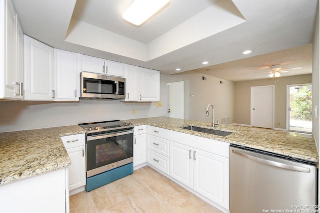 kitchen featuring appliances with stainless steel finishes, ceiling fan, sink, kitchen peninsula, and white cabinets