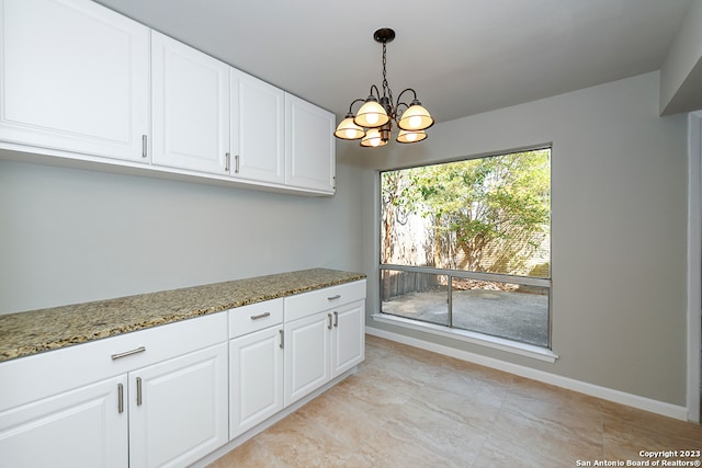 unfurnished dining area featuring an inviting chandelier and light tile floors