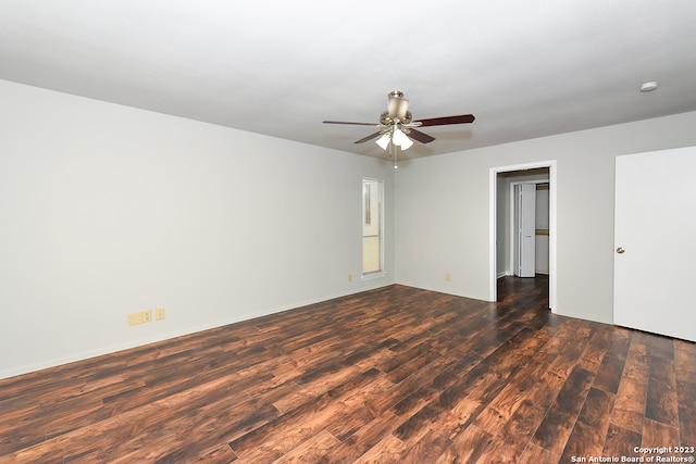 empty room with ceiling fan and dark hardwood / wood-style floors