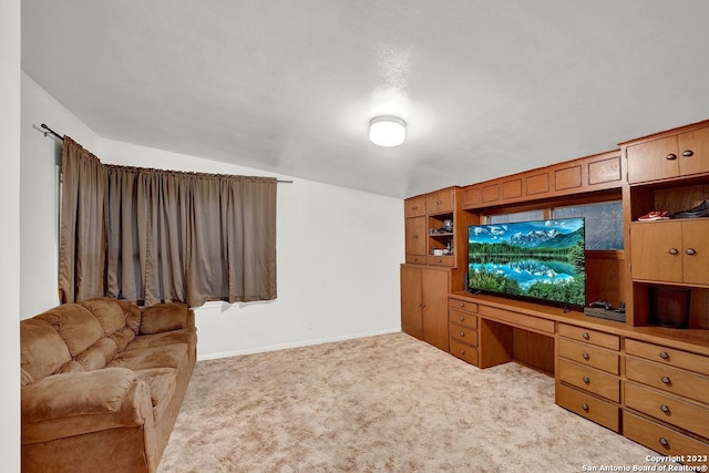 living room with light carpet, built in desk, and lofted ceiling