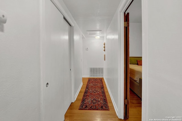 corridor with light hardwood / wood-style flooring