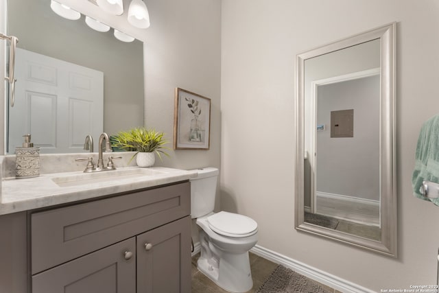 bathroom featuring toilet, tile floors, and vanity with extensive cabinet space