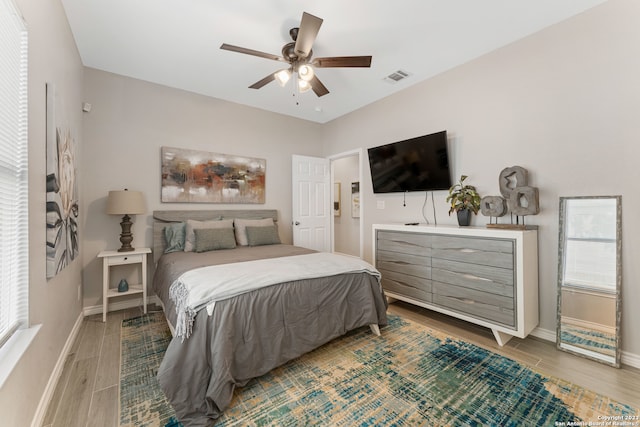 bedroom with light hardwood / wood-style floors and ceiling fan