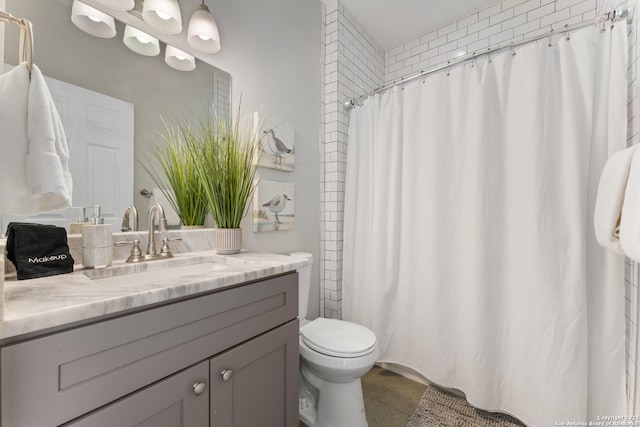 bathroom with vanity with extensive cabinet space and toilet