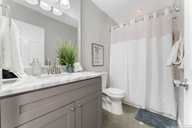 bathroom featuring tile flooring, oversized vanity, and toilet