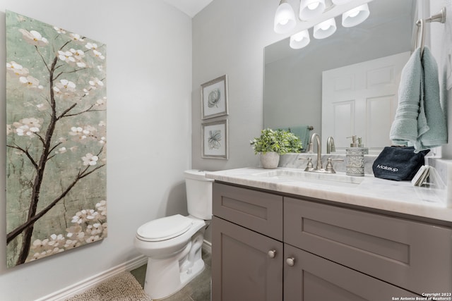 bathroom with vanity, tile floors, and toilet