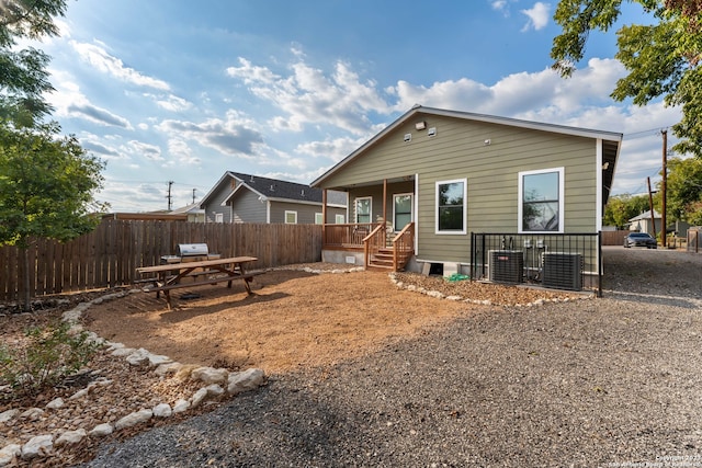 rear view of property featuring central AC unit