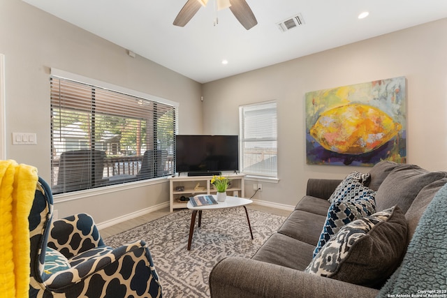 living room featuring ceiling fan, light hardwood / wood-style flooring, and a wealth of natural light