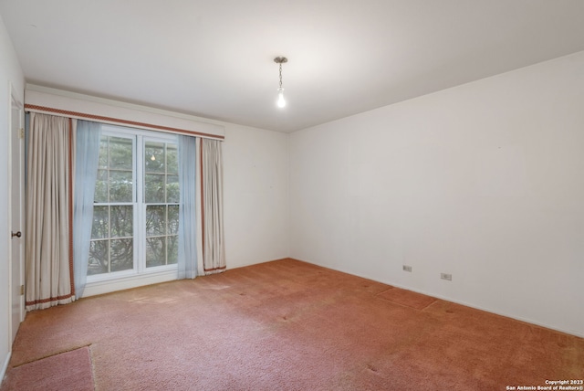 unfurnished room featuring light colored carpet