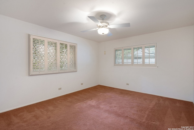 empty room with ceiling fan and carpet