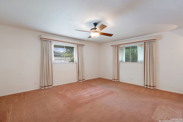 carpeted spare room with ceiling fan