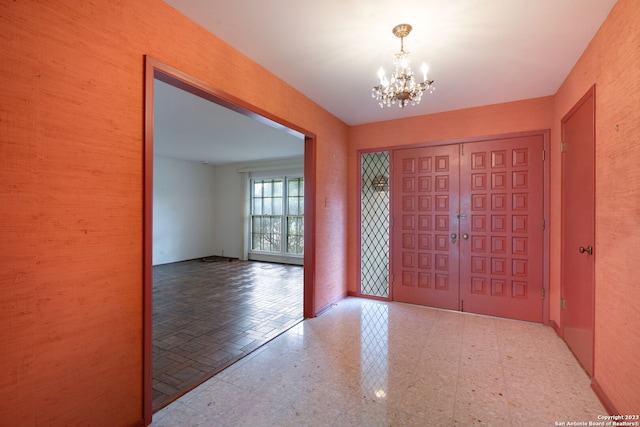 tiled entrance foyer featuring a chandelier