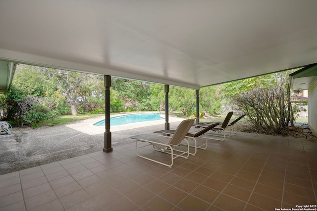 unfurnished sunroom with a pool and a healthy amount of sunlight