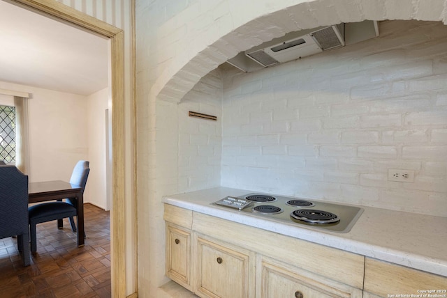 kitchen with dark parquet floors and electric cooktop