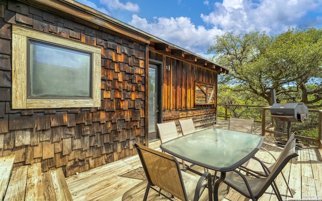 wooden terrace with a grill