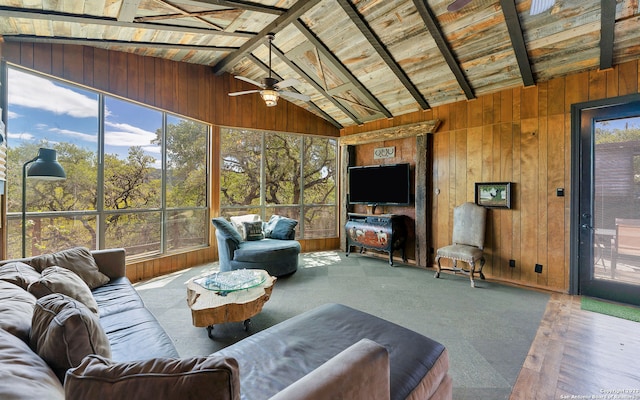 living room featuring plenty of natural light, wood ceiling, vaulted ceiling with beams, and ceiling fan