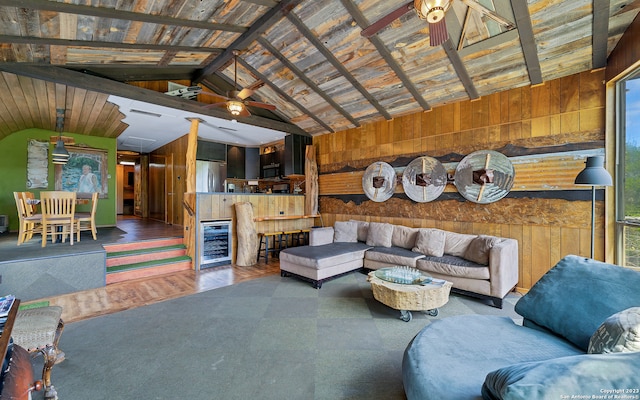 living room featuring ceiling fan, vaulted ceiling with beams, and wood ceiling