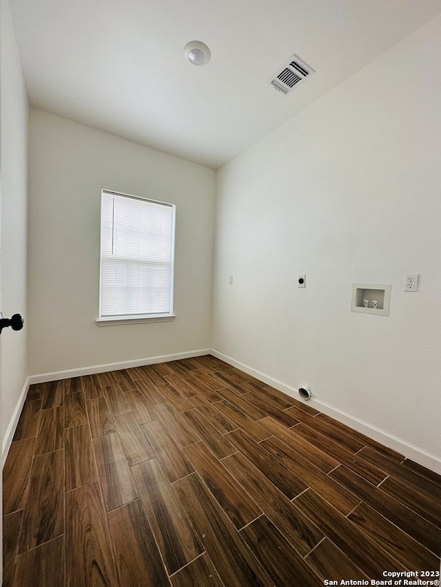 spare room with dark hardwood / wood-style flooring